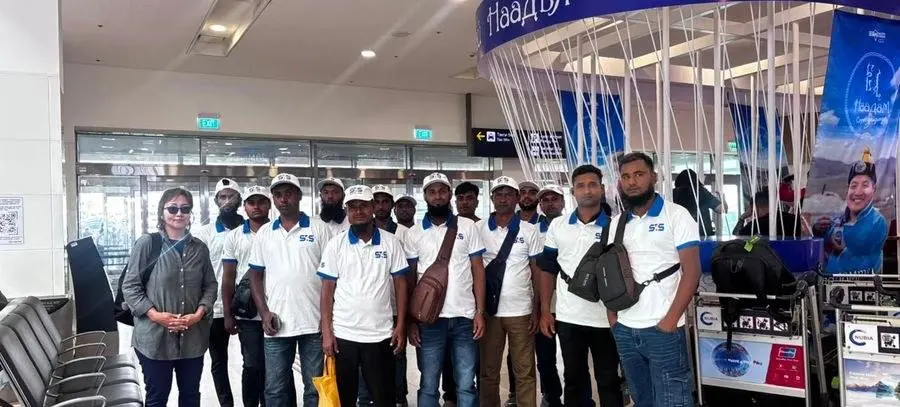 Workers gathered in the airport terminal